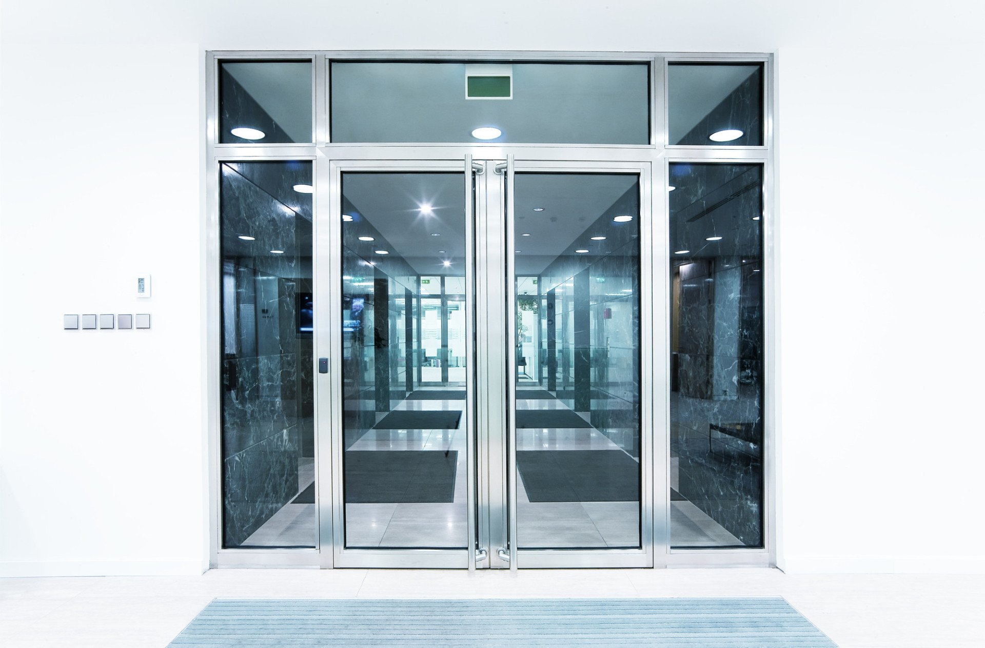 Commercial door repair engineer working on an aluminium shop door in Leeds